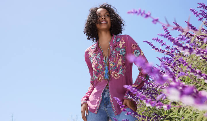 Model wearing purple embroidered button down blouse