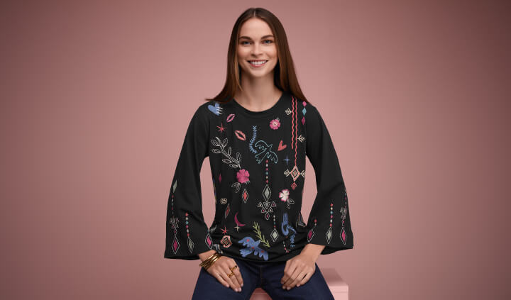 Model wearing black embroidered bell sleeve blouse