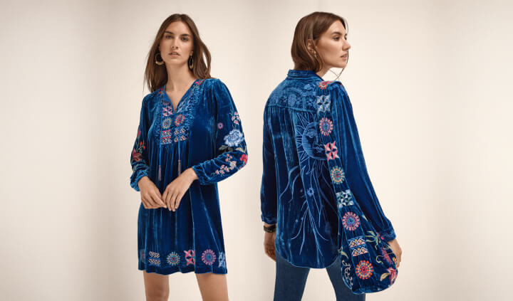 Models wearing blue velvet embroidered blouse, mini dress, and tote